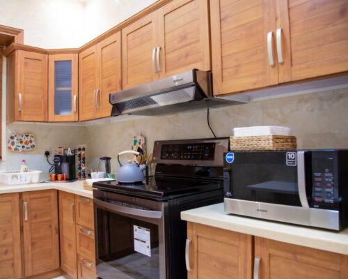 white microwave oven on brown wooden kitchen cabinet